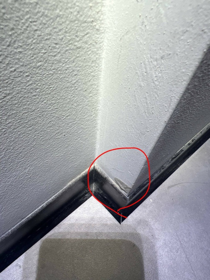 Damaged wall corner above a skirting in a new office fit-out